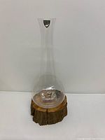 Full view of clear glass bud vase standing upright
