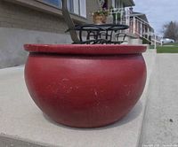 Side view of red concrete planter on step