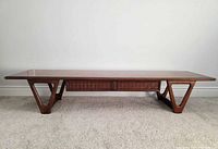 Full view of the coffee table showing top, legs and front panel