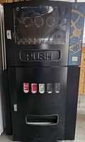 Full front view of black Seaga combo vending machine