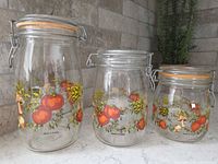 Three glass jars showing size differences and clamp lids