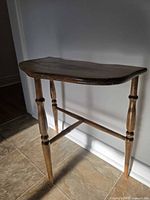 Full view of solid wood side table showing turned legs and stretcher