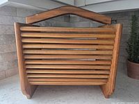 Front view showing slatted dowel sides and handle