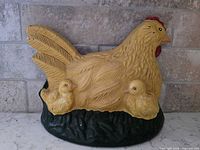 Front view of painted cast iron hen doorstop