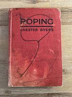 Front cover of red cloth hardcover titled "Roping" by Chester Byers