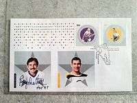 Full view of first day cover showing stamps, portraits, autograph