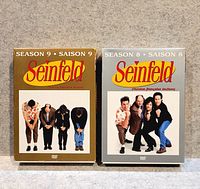 Front view of Season 9 brown slipcase and Season 8 grey slipcase
