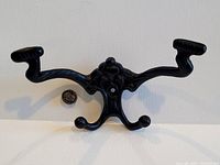 Front view of a single hook showing design and mounting hole