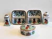 All five porcelain pieces: two square divided dishes, salt shaker, pepper shaker, oval trinket box
