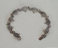 Full view of bracelet laid flat showing all fan links and clasp