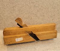Left-side view of wooden hand plane showing profile, wedge and iron