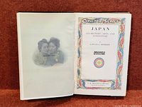 Open book showing photogravure and decorated title page