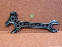Full view of wrench front side with coin for scale