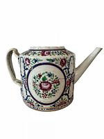 Full view of cylindrical hand-painted porcelain teapot showing handle, spout and floral decoration
