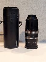 Lens standing next to hard case