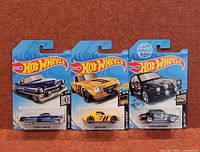 Front view of all three sealed Hot Wheels packages