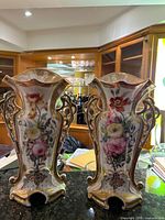Both matching hand painted porcelain vases front view