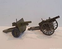 Both cast iron toy artillery pieces side by side