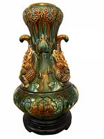 Full view of sancai glazed vase on wood stand