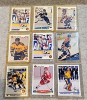 Nine sleeved cards arranged 3×3 showing fronts
