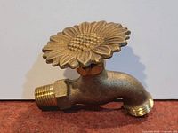 Side view of brass faucet showing sunflower handle and threaded inlet