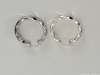 full view of both sterling silver twisted hoop earrings