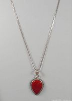 Full view of sterling silver necklace and teardrop red coral pendant