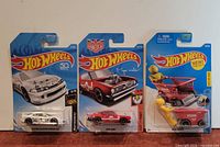 All three sealed Hot Wheels cars on cards
