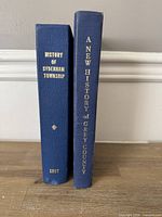 Spine view of both hardcover books standing upright