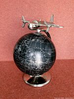 Front view showing airplane and full globe on base