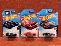 Group shot of three sealed Hot Wheels cards