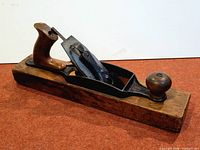 Right side view of the Stanley Bailey No.4 plane resting on wooden block