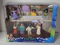 Front of sealed box showing seven Encanto figures inside window display
