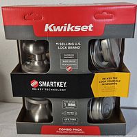 Front of sealed Kwikset SmartKey combo pack showing brand, product images and features