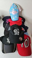 Stack of all hats showing variety and logos