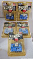 Front view of all five sealed Brother P-touch tapes in blister packaging