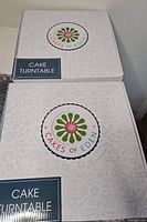 Two sealed Cakes of Eden cake turntable boxes
