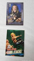 Fronts of two autographed Chris Jericho WWF trading cards