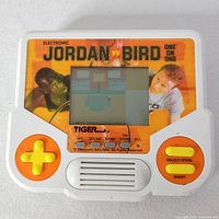 Front view showing screen, controls, graphics, branding and title