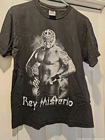 Full front view of Rey Mysterio T-shirt hanging