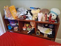 Front view of wooden bookcase headboard showing three cubby compartments and top surface
