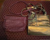 Burgundy leather bag and gold patchwork bag side by side showing overall design and straps
