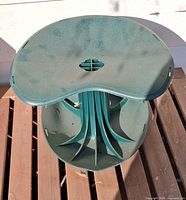 Top view of green molded-plastic gardening stool