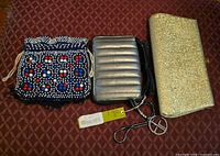 All three bags side by side: blue beaded pouch, silver quilted bag with strap, gold glitter clutch