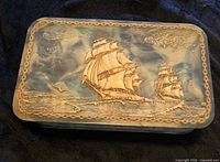 Top view showing full relief design of ships and chain border on lid