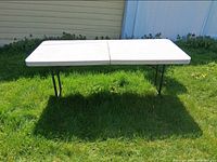 Top view of full rectangular folding table set up on grass