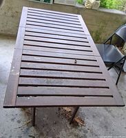 Top view of slatted ÄPPLARÖ table showing leaf seams and surface wear