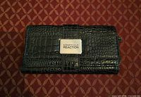 Front exterior showing croc embossing and Kenneth Cole Reaction plaque