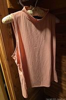 Front view of ribbed rose-peach sleeveless mock neck bodice