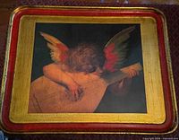 Front of tray showing cherub design, gold and red borders